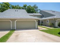 Attractive condo featuring a two-car garage, well-kept lawn, and mature trees in a great location at 15 Misners Trl, Ormond Beach, FL 32174