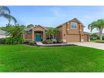 Charming single-Gathering home with a well-manicured lawn and a beautiful blue front door at 1910 Creekwater Blvd, Port Orange, FL 32128