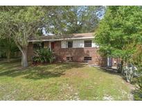 Charming brick two-story home with a well-maintained front yard and mature trees at 2032 Yorkshire Dr, Deland, FL 32724