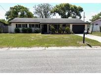 Charming single-story home with a well-manicured lawn and mature landscaping at 3 Cassia Ln, Debary, FL 32713