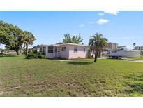 Charming single-story home with a well-maintained lawn and boat on a trailer in the driveway at 3267 S Peninsula Dr, Daytona Beach, FL 32118