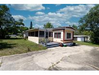 Charming single-story home featuring a well-maintained lawn, concrete driveway, and inviting entryway at 487 Collins St, Ormond Beach, FL 32174