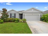 Charming single-story home with a well-manicured lawn and inviting entrance and two car garage at 1002 River Falls Cir, Deland, FL 32720
