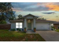 Charming single-story home featuring a two-car garage, well-manicured lawn and pleasing landscaping at 1092 Gage Ave, Deltona, FL 32738