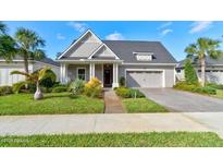 Charming single-Gathering home featuring a well-manicured lawn and attached two-car garage at 112 Chelsea Place Ave, Ormond Beach, FL 32174