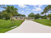 Charming ranch style home with new driveway and mature landscaping at 1518 Lakeside Dr, Deland, FL 32720