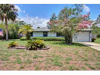 Charming single-story home with lovely landscaping and a well-manicured lawn at 1828 West Pkwy, Deland, FL 32724