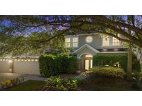 Charming two-story home with a manicured lawn and lush landscaping, offering great curb appeal at 227 Blue Crystal Dr, Deland, FL 32720