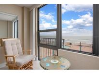 Relaxing balcony view with chair and table overlooking ocean at 3043 S Atlantic Ave # A040, Daytona Beach, FL 32118
