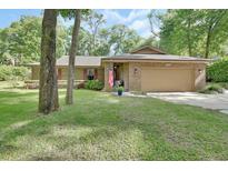 Charming one-story brick home featuring a well-manicured lawn and a welcoming front porch at 535 Black Ironwood Dr, Deland, FL 32724