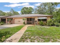 Inviting single-story home featuring a well-manicured lawn and charming curb appeal at 71 Crooked Pine Rd, Port Orange, FL 32128