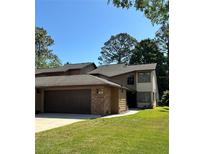 Two-story home with a brick front, attached garage and well-maintained lawn at 96 Old Barn Trl, Ormond Beach, FL 32174