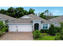 Charming single-Gathering home featuring a three-car garage, paver driveway, and well-manicured landscaping at 978 Victoria Hills S Dr, Deland, FL 32724