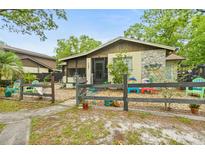 Charming single-story home with a decorative stone facade and unique decorative, colorful lawn decor at 127 Cypress Pond Rd, Port Orange, FL 32128