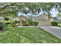Charming single-story home with well-manicured lawn and mature trees providing ample shade and curb appeal at 1310 Pup Fish Ln, Deland, FL 32724