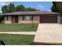 Charming single-story brick home featuring an attached garage, and a well-maintained front yard at 1556 Ferendina Dr, Deltona, FL 32725