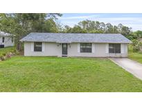 Charming single-story home featuring a well-maintained lawn and a classic facade at 2127 3Rd Ave, Deland, FL 32724