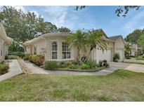 Charming home boasts a well-manicured lawn, lush landscaping, and a two-car garage at 217 Lourdan Ct, Debary, FL 32713