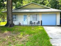 Charming single-story home featuring a light-colored exterior and a neatly manicured front lawn at 2380 Spring Hollow Drive, Orange City, FL 32763