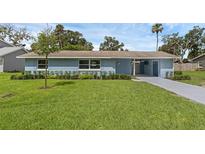 Charming single story home with a well-manicured lawn and appealing landscaping at 2720 Kumquat Dr, Edgewater, FL 32141