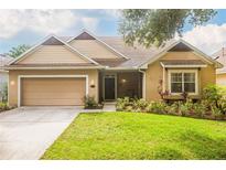 Charming single-story home with a well-maintained lawn and attached two-car garage in a suburban neighborhood at 307 Ravenshill Way, Deland, FL 32724