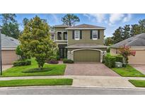 Charming two-story home featuring a brick driveway and a well-manicured lawn at 3839 Calliope Ave, Port Orange, FL 32129