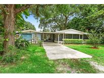 Charming single-story home with lush landscaping and a welcoming driveway at 507 Sand Ave, Apopka, FL 32703