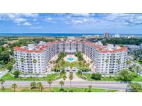 Stunning aerial view of a coastal condo building featuring a central pool and lush landscaping at 1 John Anderson Dr # 3170, Ormond Beach, FL 32176
