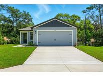 Charming single-Gathering home with a two-car garage and well-manicured lawn at 1161 Kenway Ave, Deltona, FL 32738