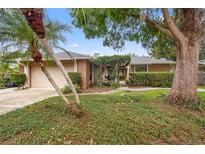 Charming single Gathering home featuring lush landscaping and a welcoming entrance at 1261 Burning Tree Ln, Winter Park, FL 32792