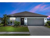 Charming single-story home featuring a well-manicured lawn and a two-car garage, perfect for comfortable living at 1323 Donatello Ln, Winter Haven, FL 33884