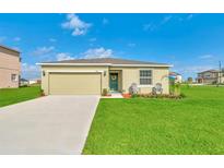 Charming single-story home featuring a well-maintained lawn, neutral exterior, and a two-car garage at 136 Columbia Dr, Kissimmee, FL 34759