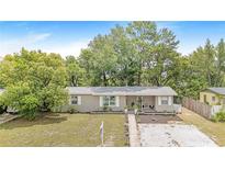 Charming single-story home with a well-manicured lawn and freshly painted exterior at 1455 Whitewood Dr, Deltona, FL 32725
