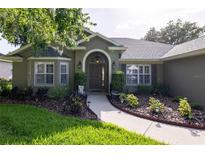 Charming home featuring a meticulously landscaped front yard and inviting front entrance at 19232 Park Place Blvd, Eustis, FL 32736