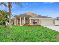 Charming single-story home with a well-manicured lawn, lush landscaping, and a two-car garage at 2263 Catbriar Way, Oviedo, FL 32765