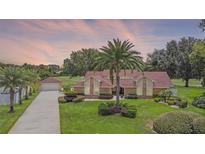 Beautiful home with lush landscaping, a long driveway, and a detached garage at 3 Pine Meadow Ct, Debary, FL 32713