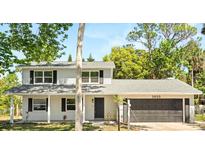 Charming two-story home with a well-manicured lawn and a classic brick facade at 3655 Scott St, Port Orange, FL 32129