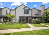 Charming townhouse featuring a well-maintained lawn and colorful, multi-tone exterior at 874 Commonwealth Ct, Casselberry, FL 32707