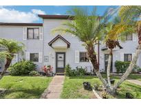 Charming townhome featuring mature landscaping and inviting front entrance at 903 Deer Springs Rd, Port Orange, FL 32129