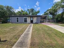 Charming single-story home with a covered carport and walkway to the front door at 922 Saxon Blvd, Deltona, FL 32725