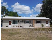 Charming single-story home featuring a durable metal roof and neutral-colored siding, perfect for low-maintenance living at 942 Lemon Bluff Rd, Osteen, FL 32764
