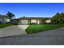 Charming single-story home with a well-manicured lawn and attached one-car garage at 10 Venetian Cir, Port Orange, FL 32127
