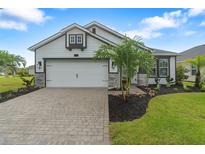 Charming one-story home featuring a two-car garage, well-maintained landscaping, and a welcoming facade at 141 Mosaic Blvd, Daytona Beach, FL 32124