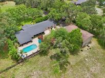 Expansive property featuring a refreshing pool and well-maintained grounds, perfect for outdoor living at 1555 Mercers Fernery Rd, Deland, FL 32720