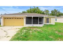 Charming single-story home with a large garage and screened porch in a quiet neighborhood with blue skies overhead at 1725 12Th St, Orange City, FL 32763