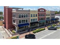 Stylish three-story mixed-use building with varied architectural details and ample street parking at 208 Wall St # 204, Daytona Beach, FL 32114
