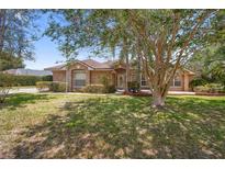 Charming brick home with a manicured lawn and mature landscaping at 2478 Unionville Dr, Deltona, FL 32725
