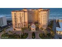 A grand beach-front condo features lush landscaping, and elegant Mediterranean architecture with stunning views at 2515 S Atlantic Ave # 203, Daytona Beach, FL 32118