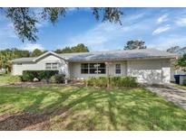 Charming single-story home featuring a well-maintained lawn and an attached two-car garage at 2676 Palm Terrace St, Deland, FL 32720