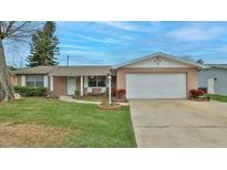 Charming single-story home featuring an attached two-car garage and a well-manicured front lawn at 2970 Lantern Dr, South Daytona, FL 32119